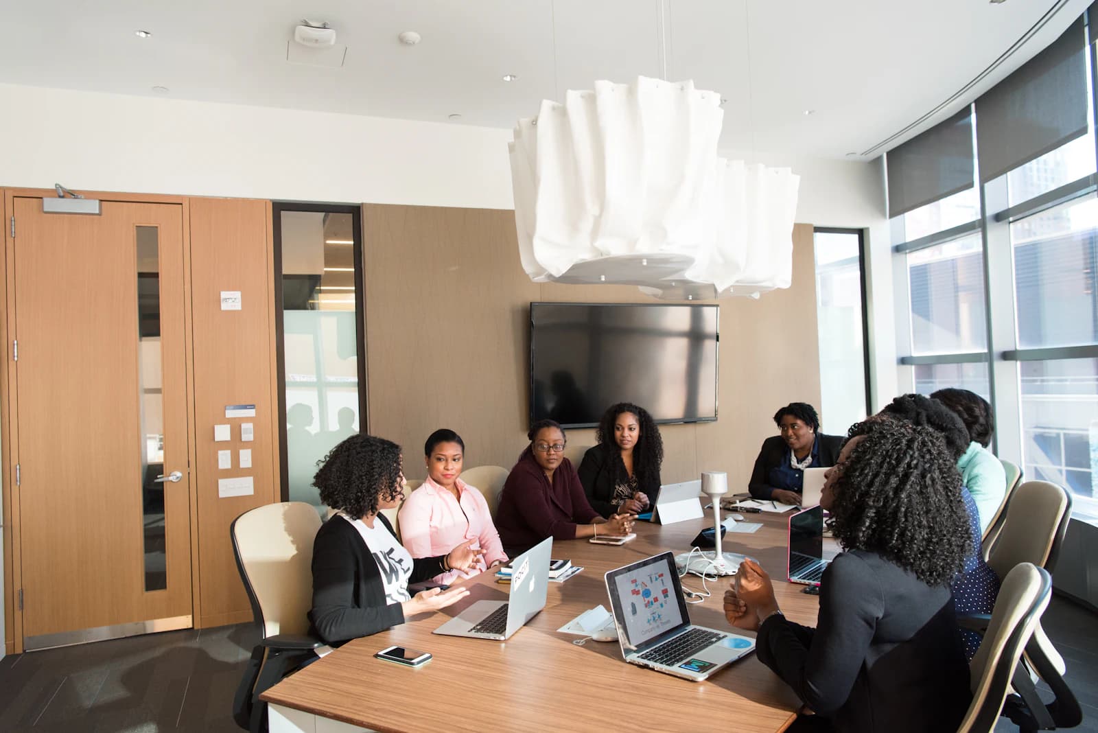 A committee meeting around a conference table
