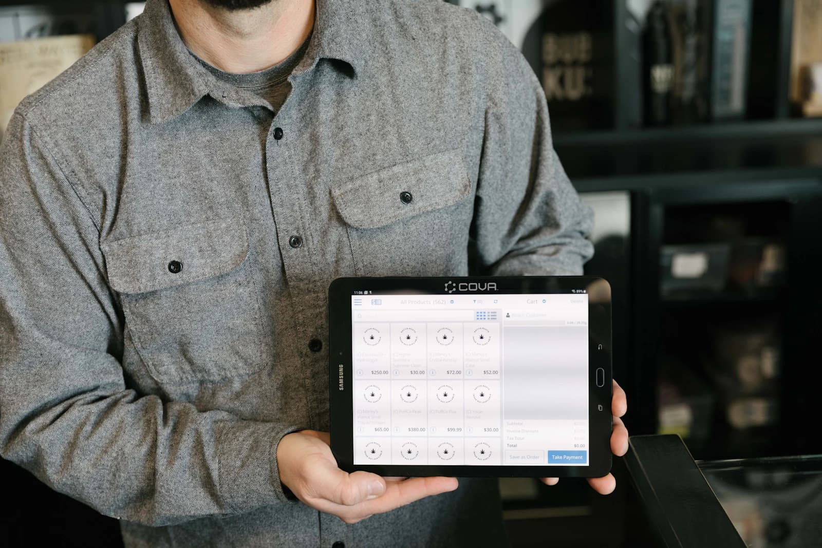 A warehouse worker holding a tablet with a workflow app