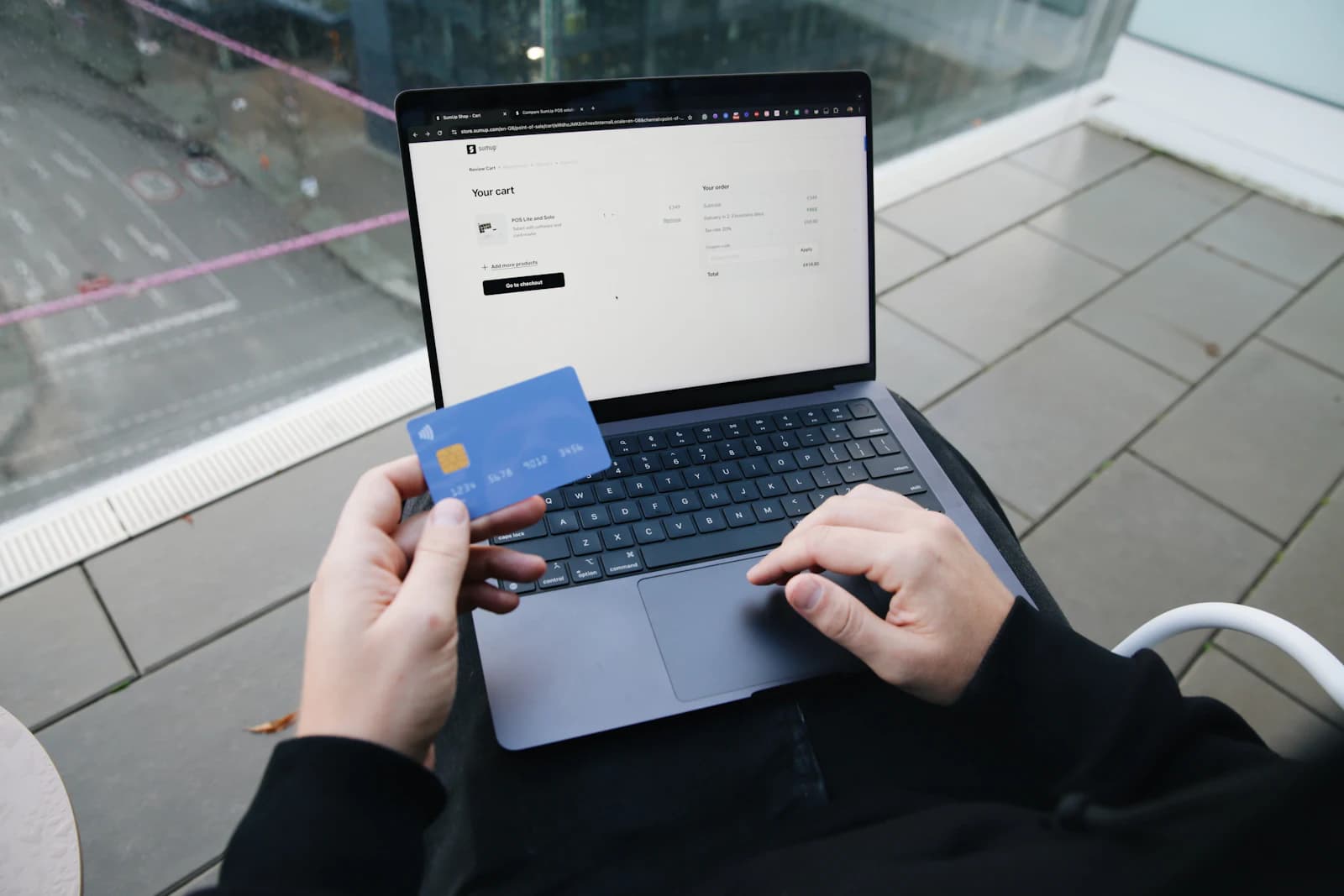 A customer paying online with a card at a laptop