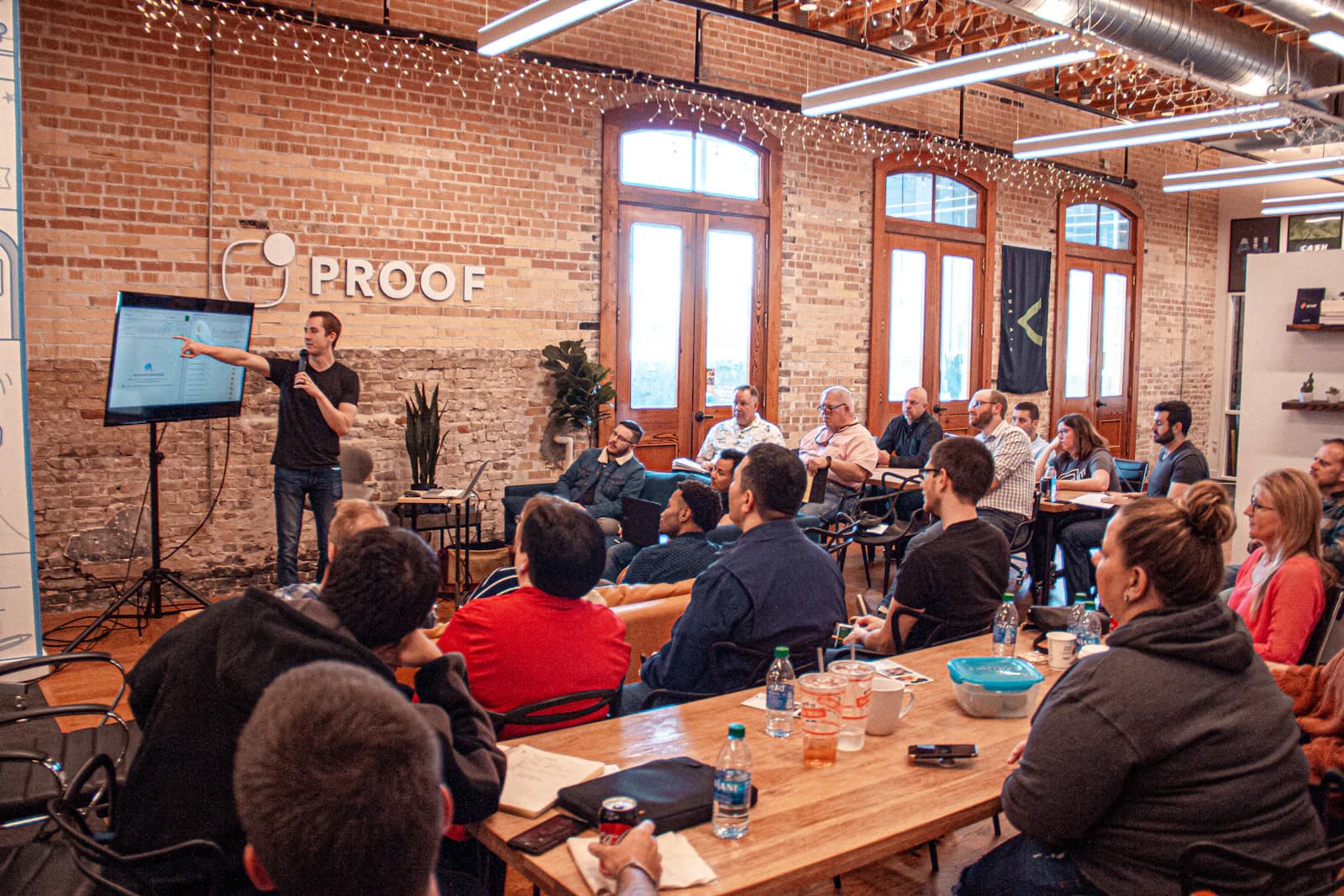A workshop room with a presenter and a full audience