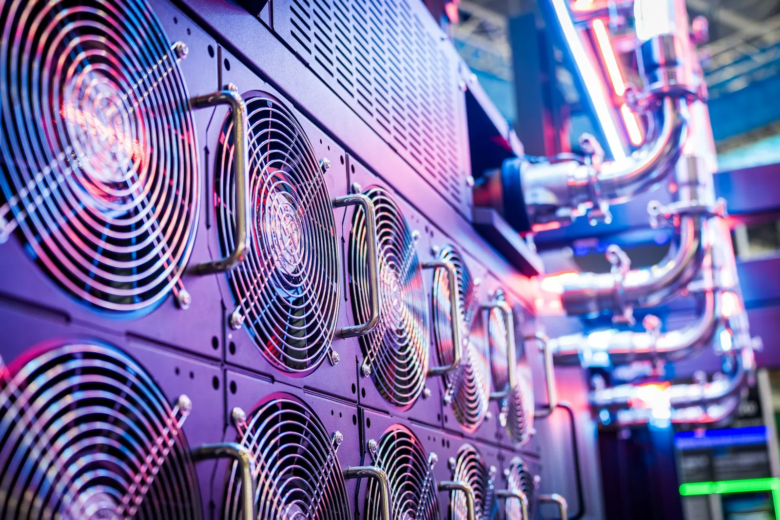 Close-up of server cooling fans in a data center lit in purple and blue