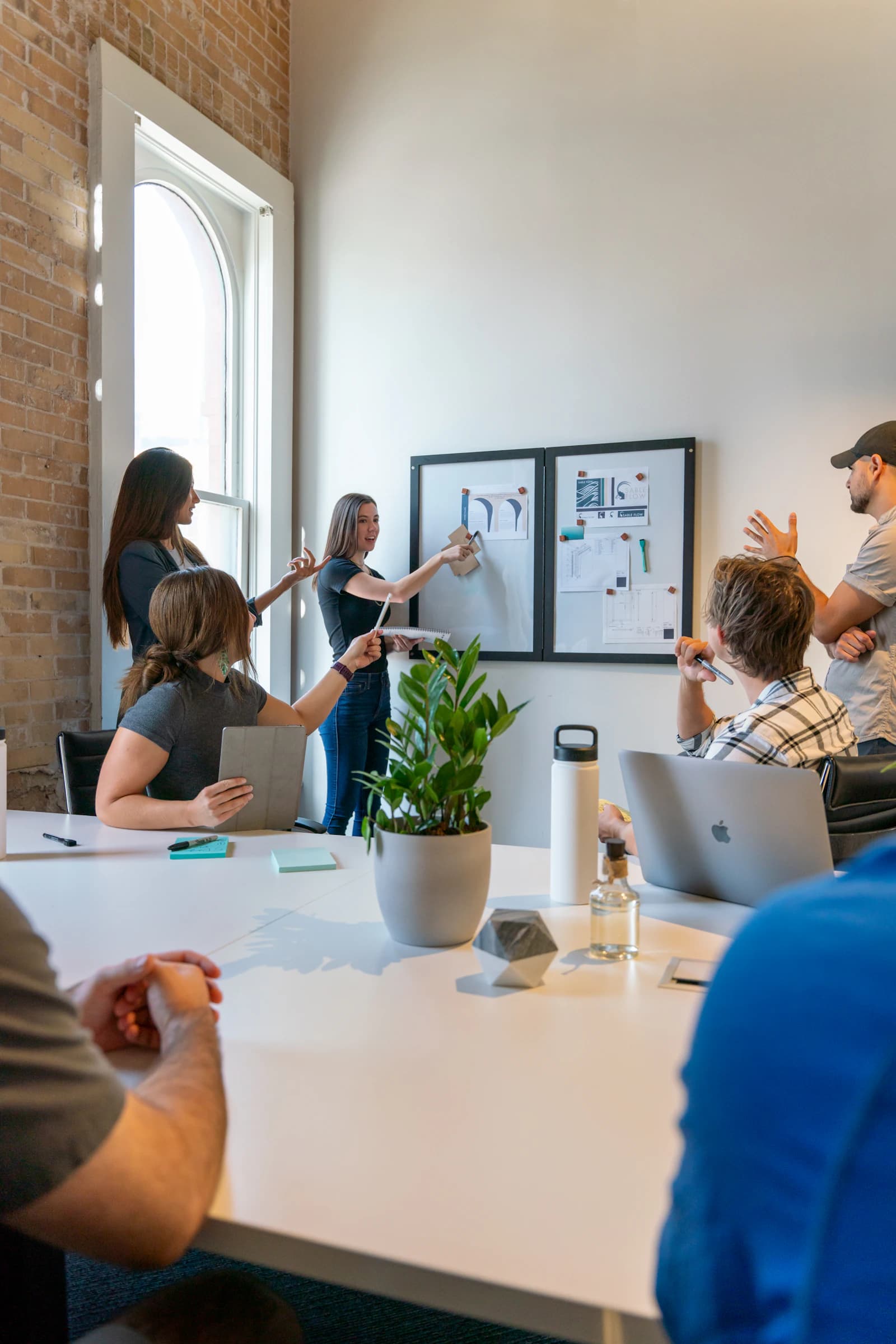 A team reviewing an architecture board in a meeting room