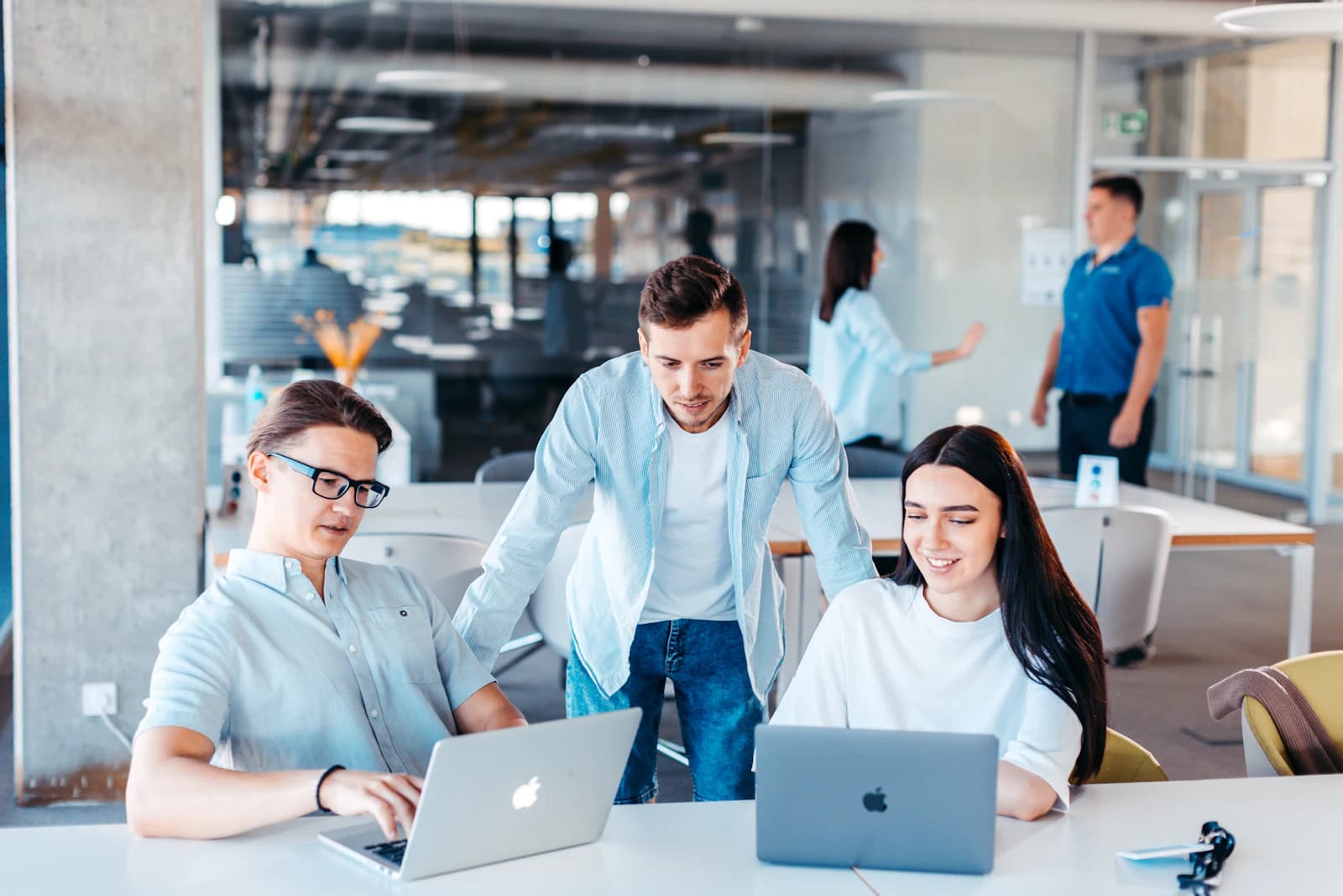 A product team working around their laptops in a bright office