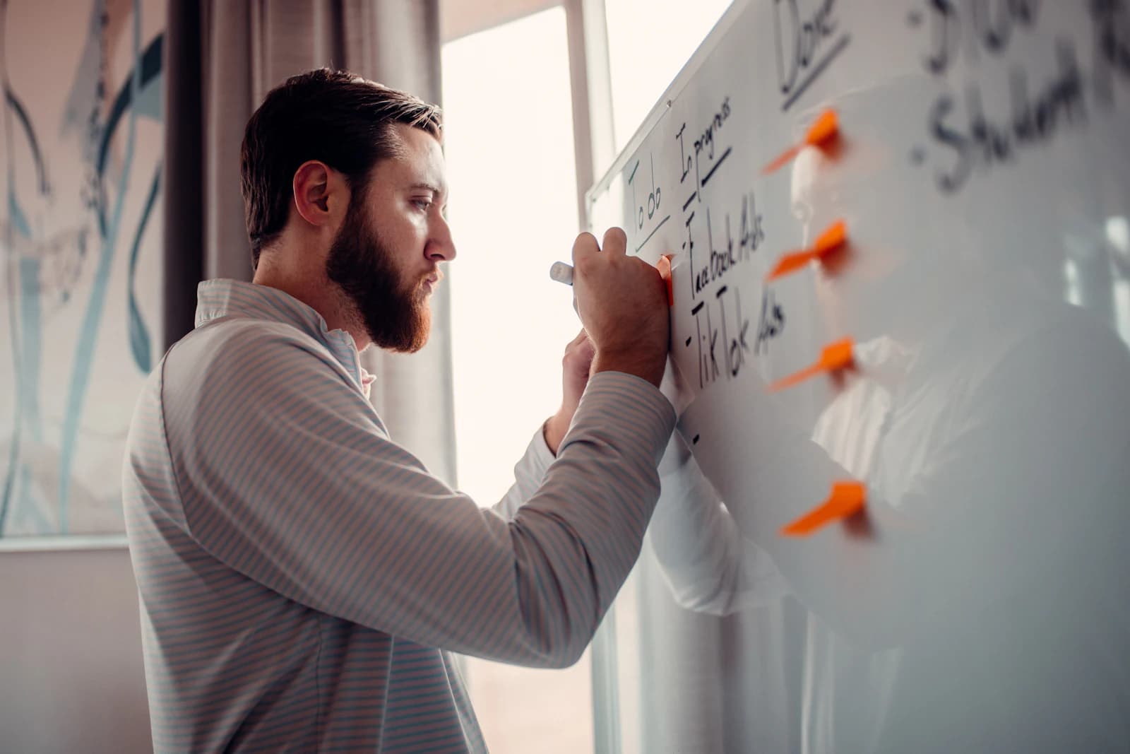 An architect sketching a system on a whiteboard