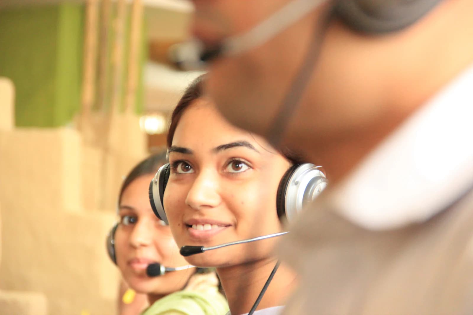 Customer service agents with headsets at their workstations