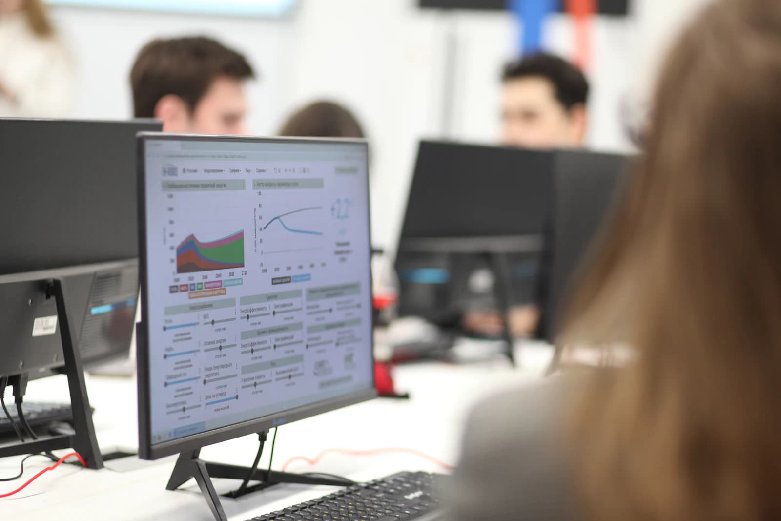 Colleagues in an office with a chart open on a monitor