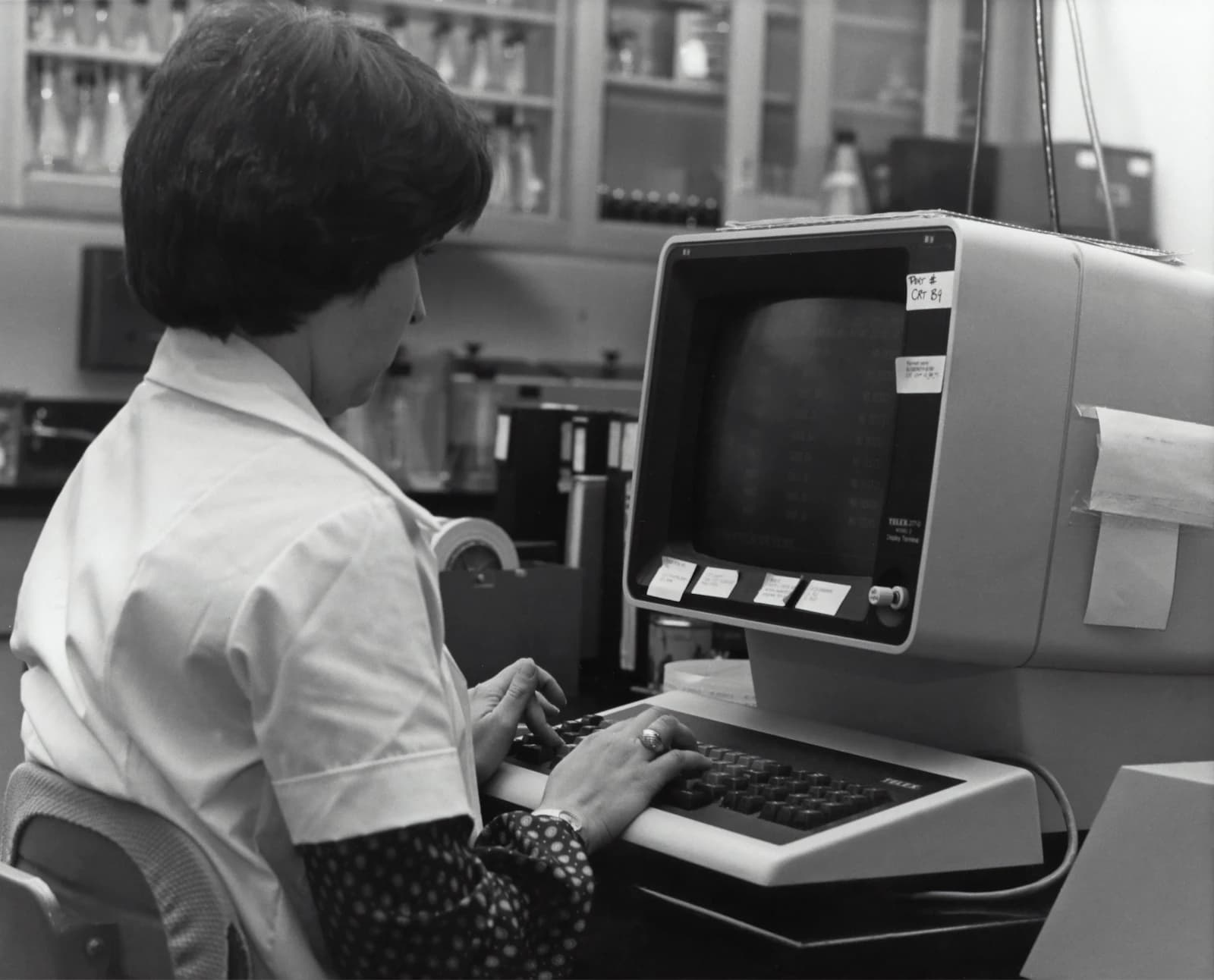 A person working at an early desktop computer