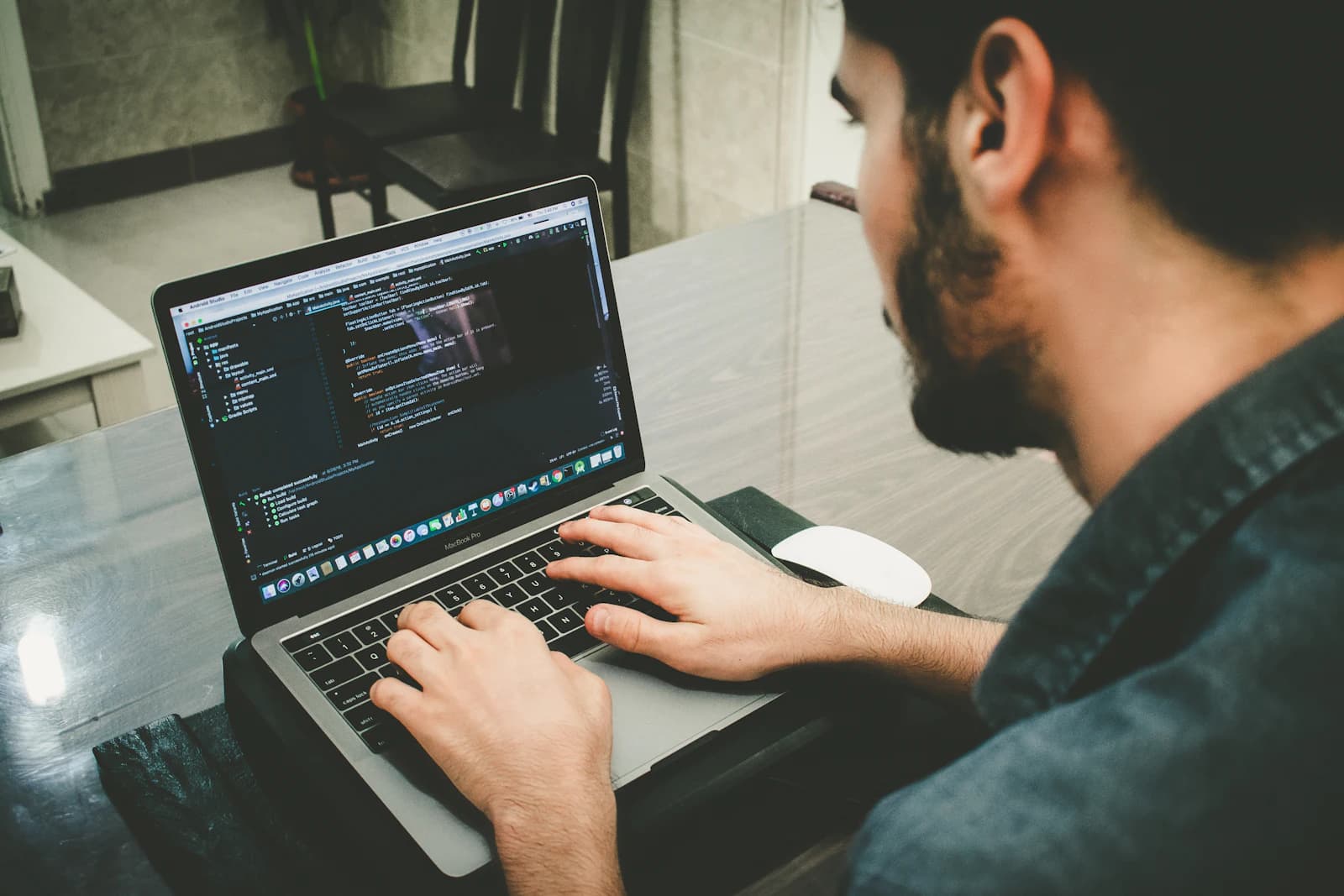 An engineer testing code on a laptop