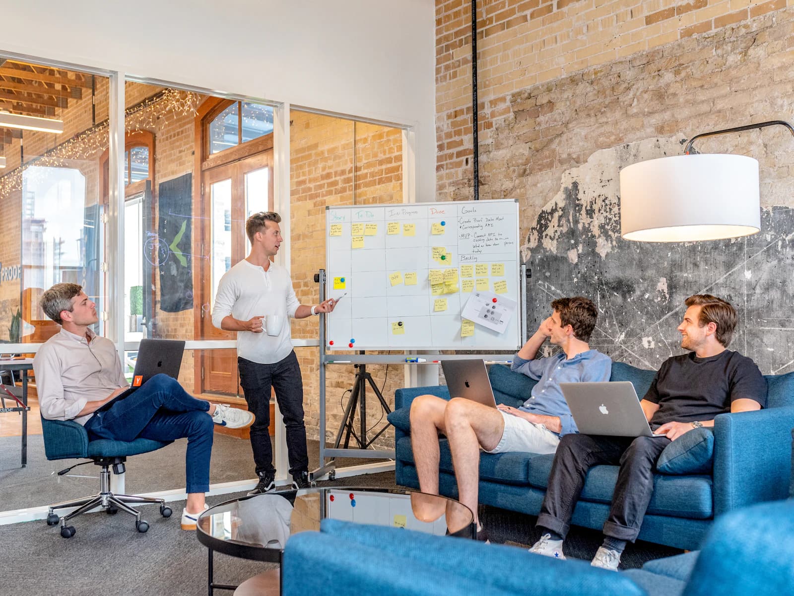 A product team planning at a whiteboard in an open office