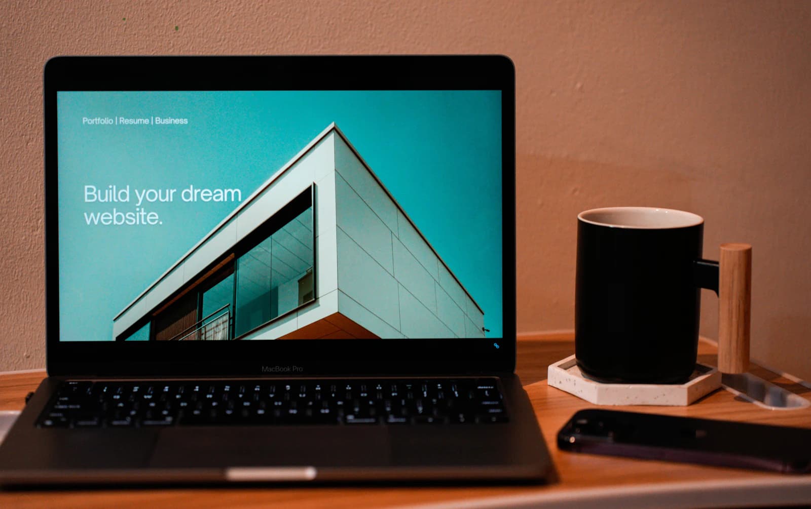 A laptop showing a website on a wooden desk