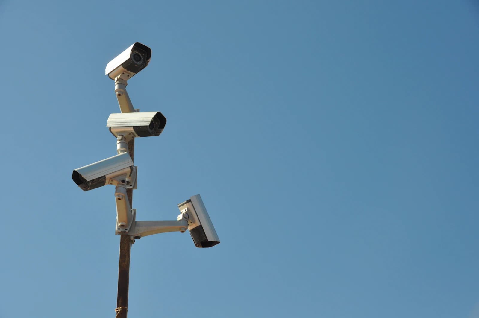 Security cameras on a pole against a blue sky