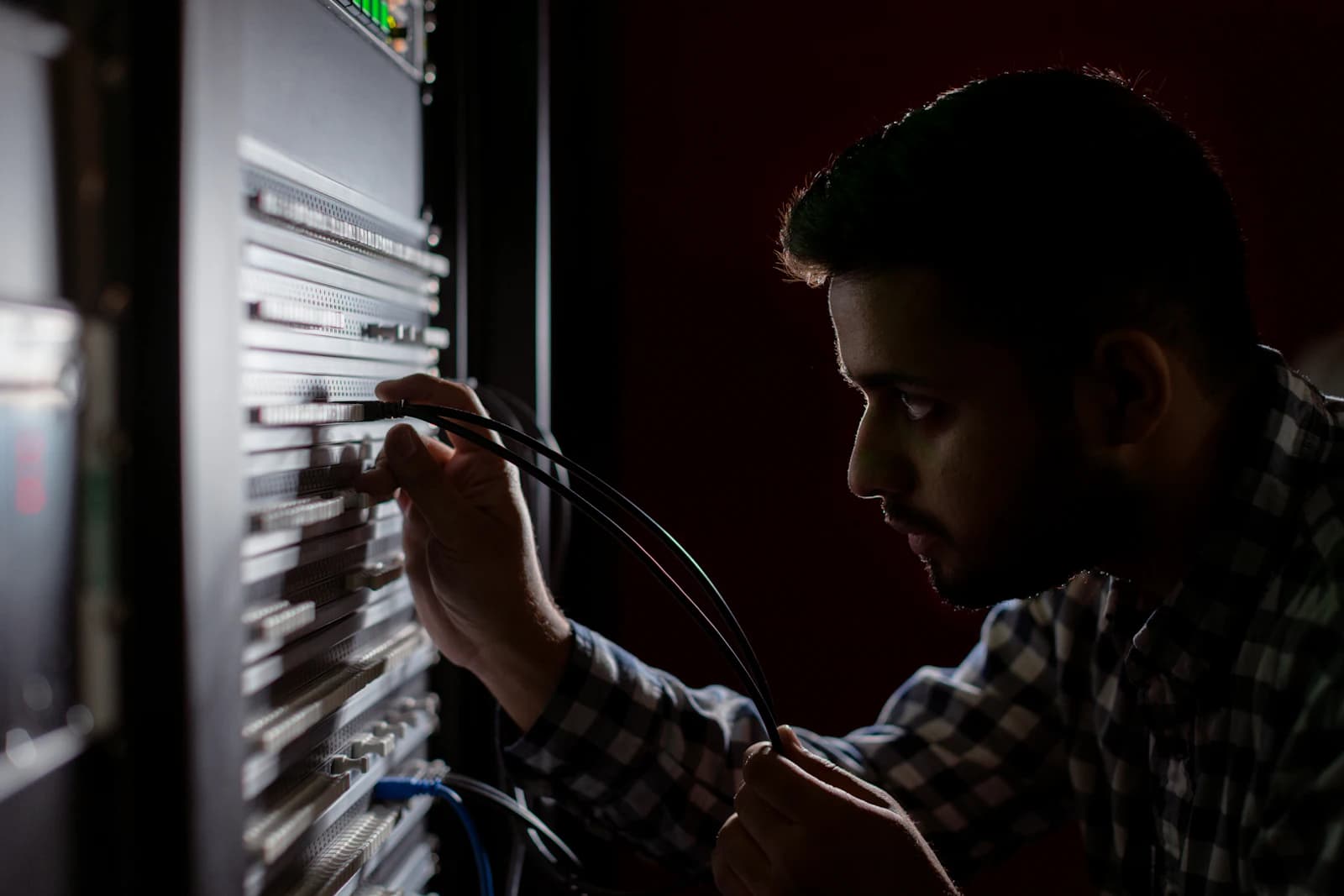An engineer working on equipment in a server rack