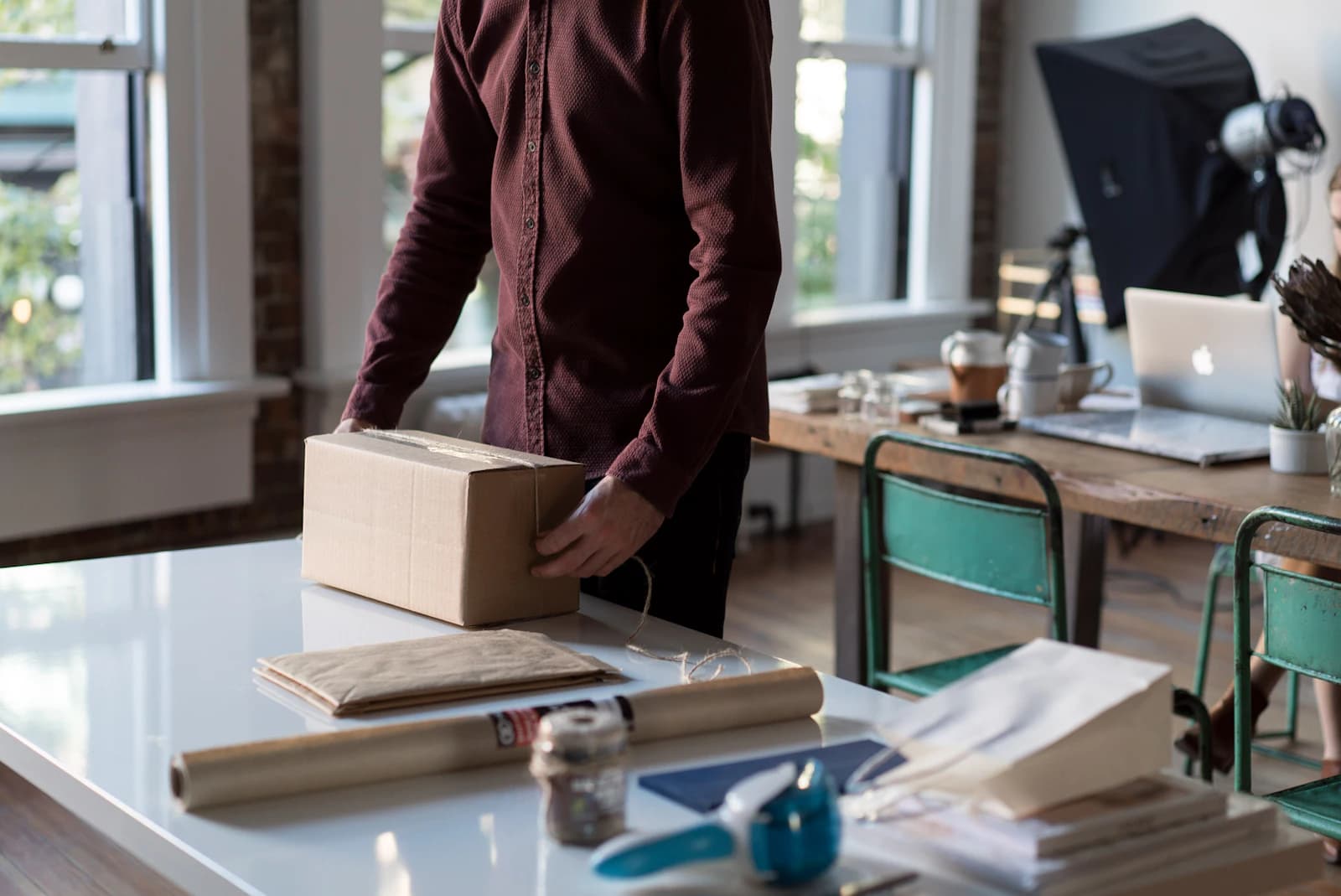 A seller packing an order at a desk