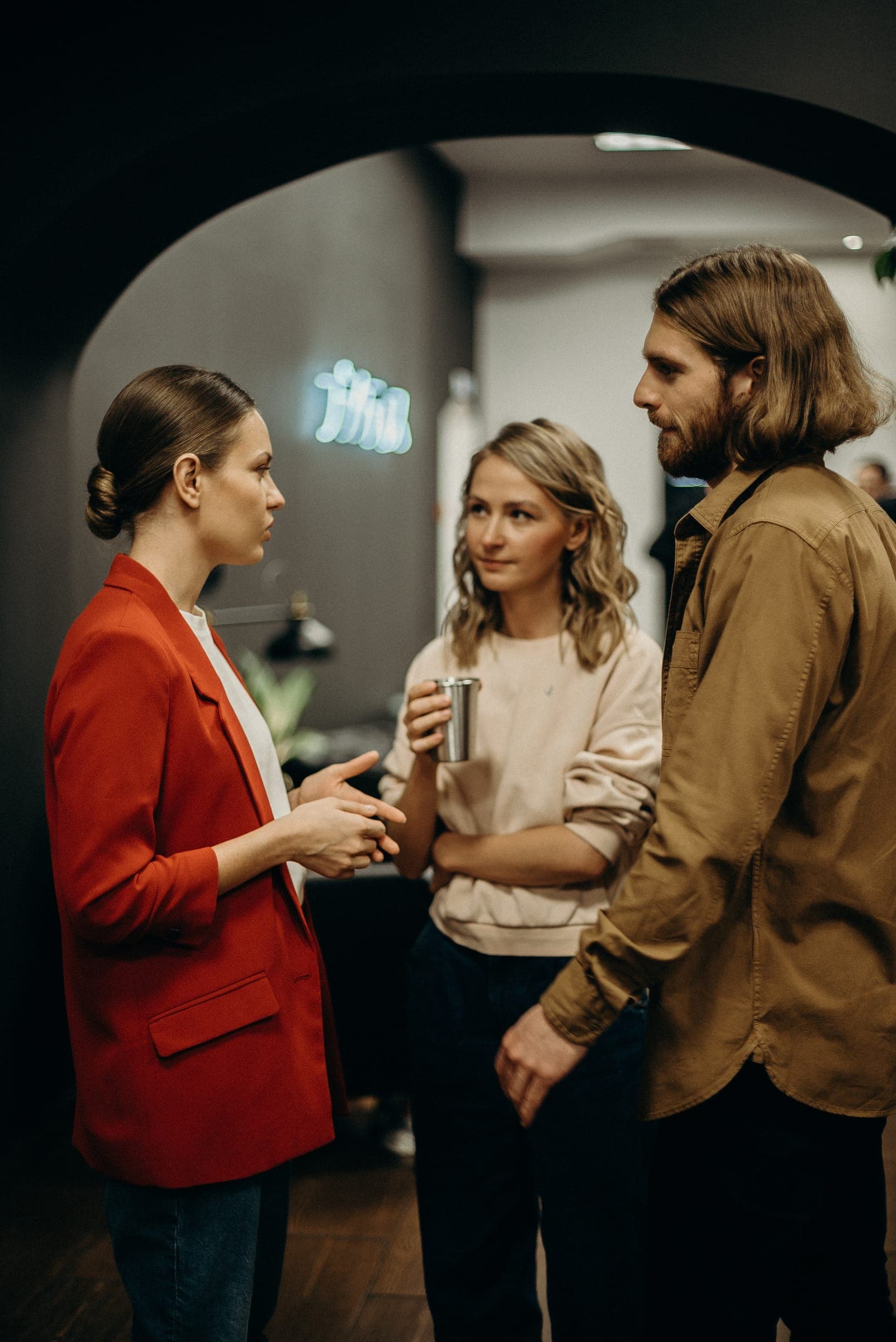 Three colleagues talking in an office